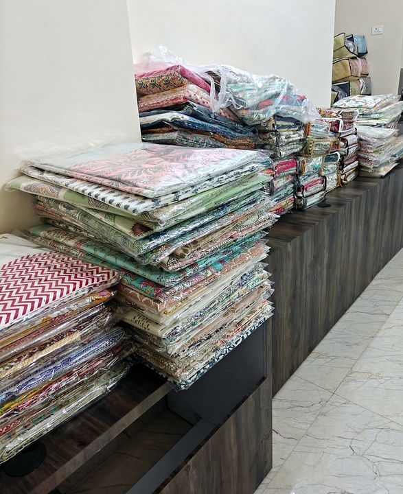 Stacks of hand block printed cotton bedsheets on the counter