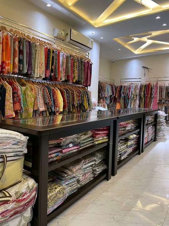 Saree wall and display counters with folded suit sets